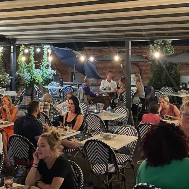 Diners on the rooftop patio at The Roost
