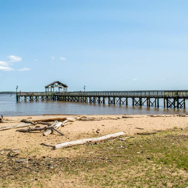 view of the fishing pier and water from the sandy beaches of Leesylvania State Park