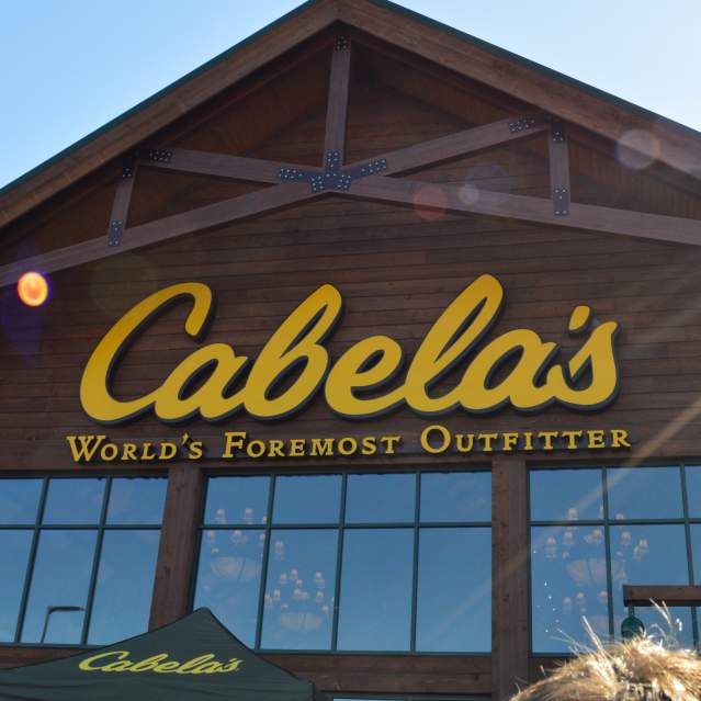 "Cabela's World's Foremost Outfitters" is written in yellow on the storefront of a brown building