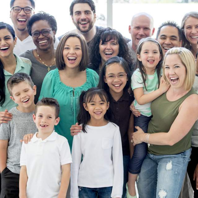 A diverse group of people standing together and smiling