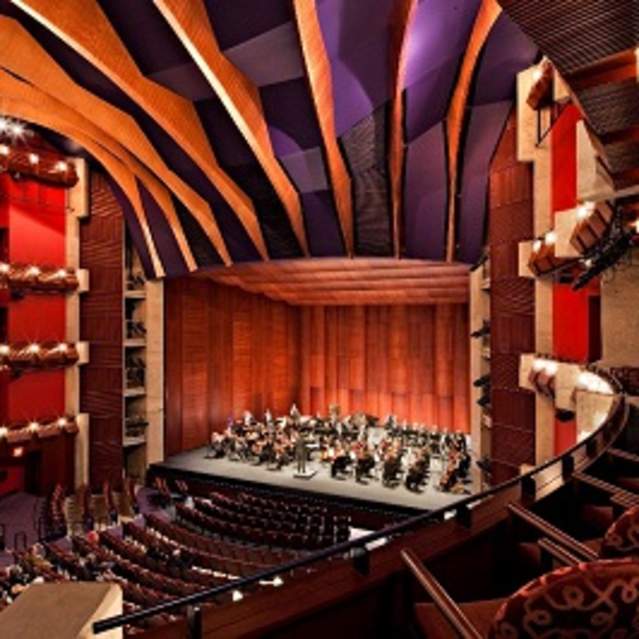 an orchestra playing on the stage of a theater