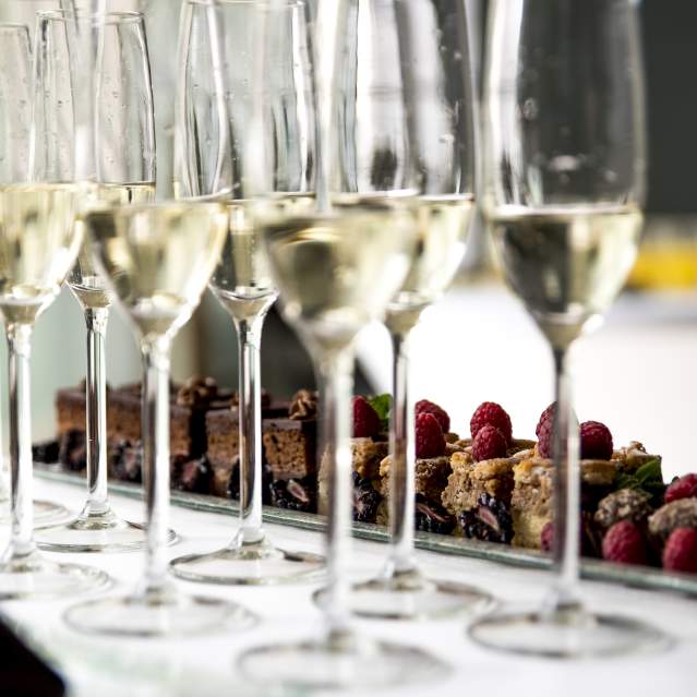 Champagne flutes and a tray of sweets