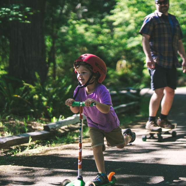 A kid riding a scooter
