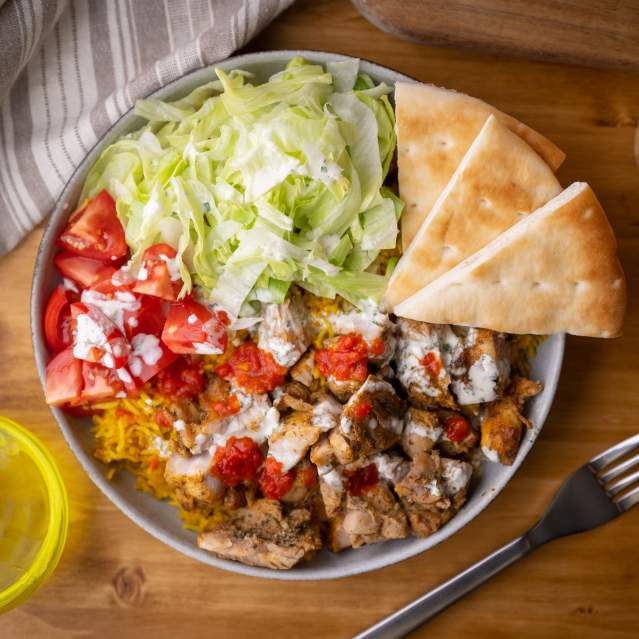 A Halal rice bowl on a table in San Marcos, Texas