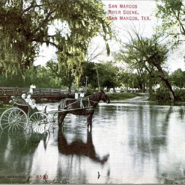 A couple in a buggy post in the San Marcos river