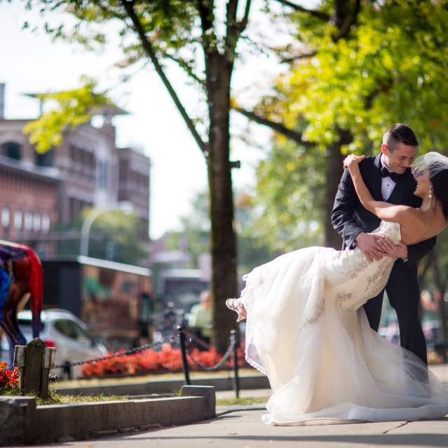 groom dipping his bride on broadway