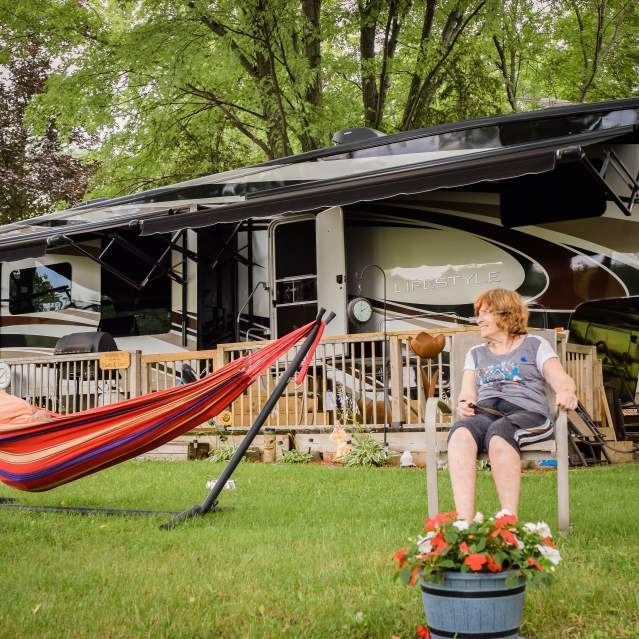 family relaxing at campsite