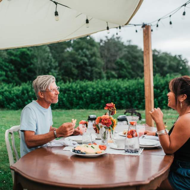 Couple eating at farm patio