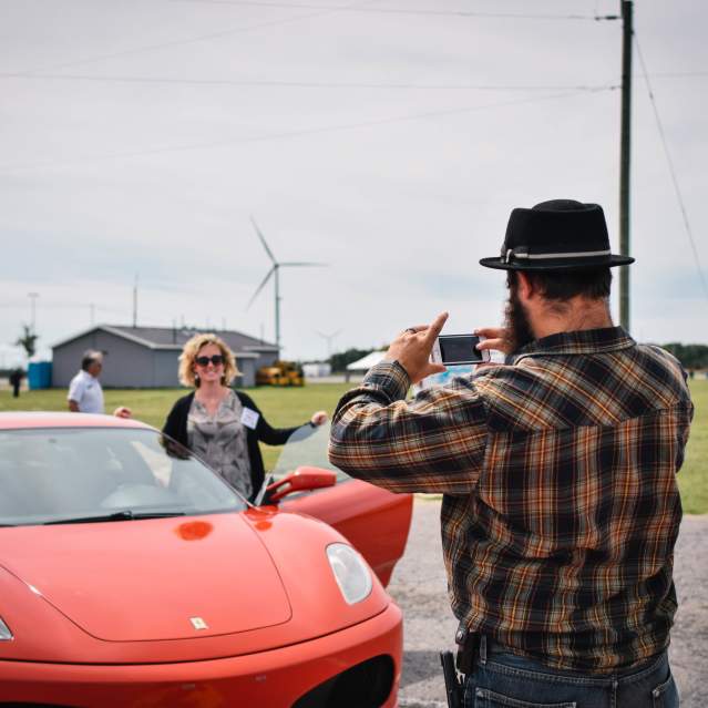 Man taking photo of exotic car