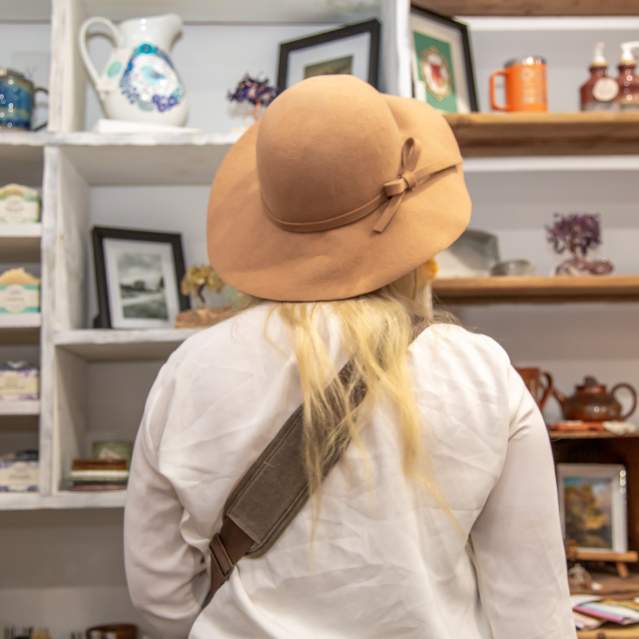 woman looking at shelf in store