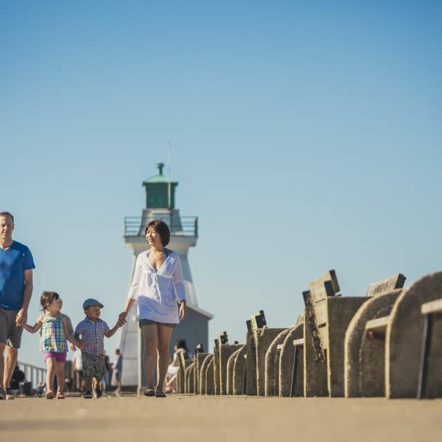 Family walking on pier