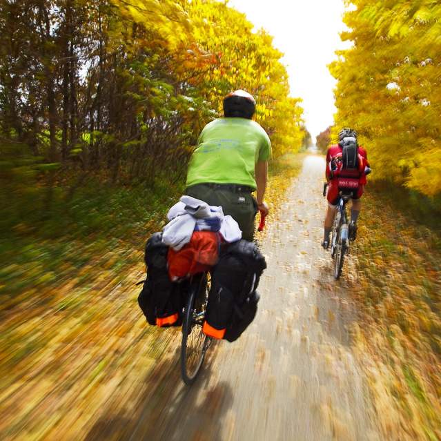 2 people cycling in fall