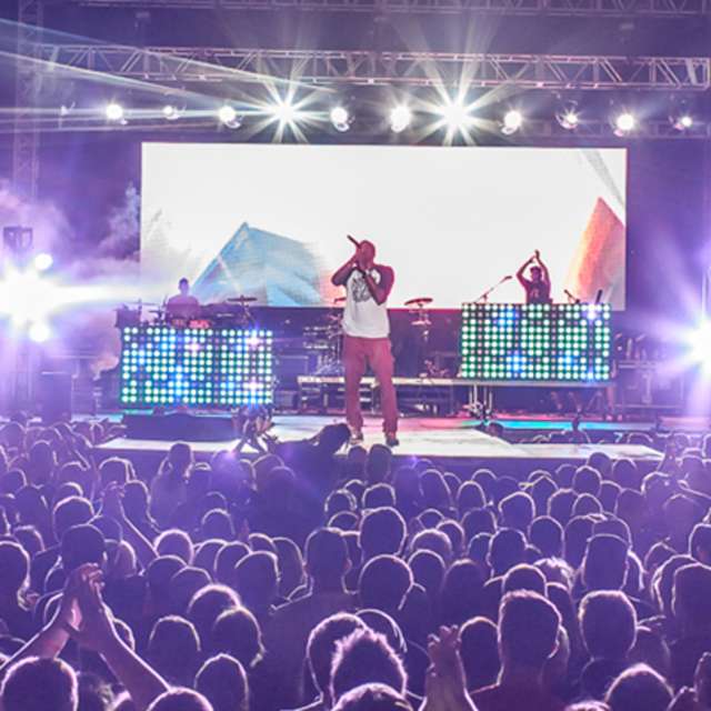 Crowd surrounding the stage at night during the Uprise Festival