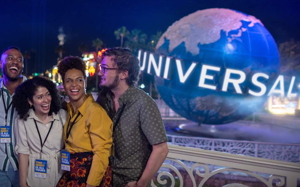 Group for meeting at Universal Orlando Resort by globe at night 1:1 aspect ratio