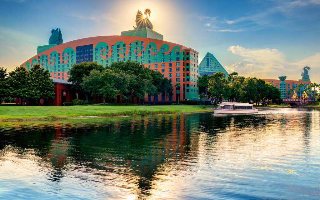 Walt Disney World Swan and Dolphin Resort exterior with boat at dusk