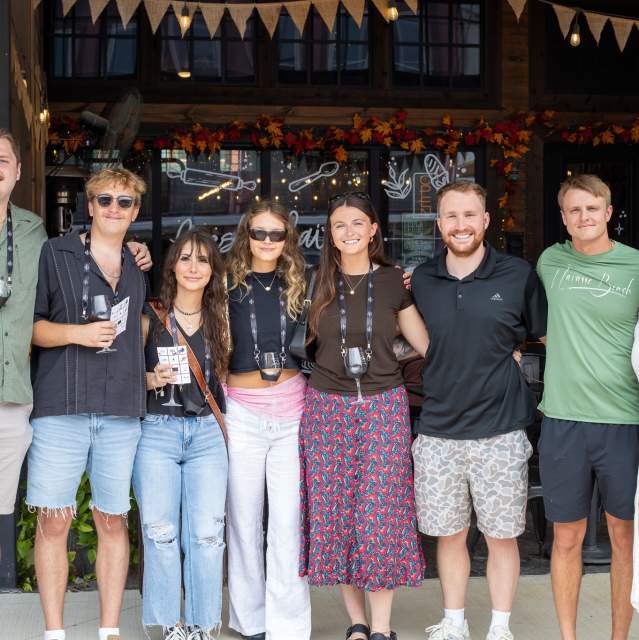Friends posing together during a Downtown Denison Wine Walk event