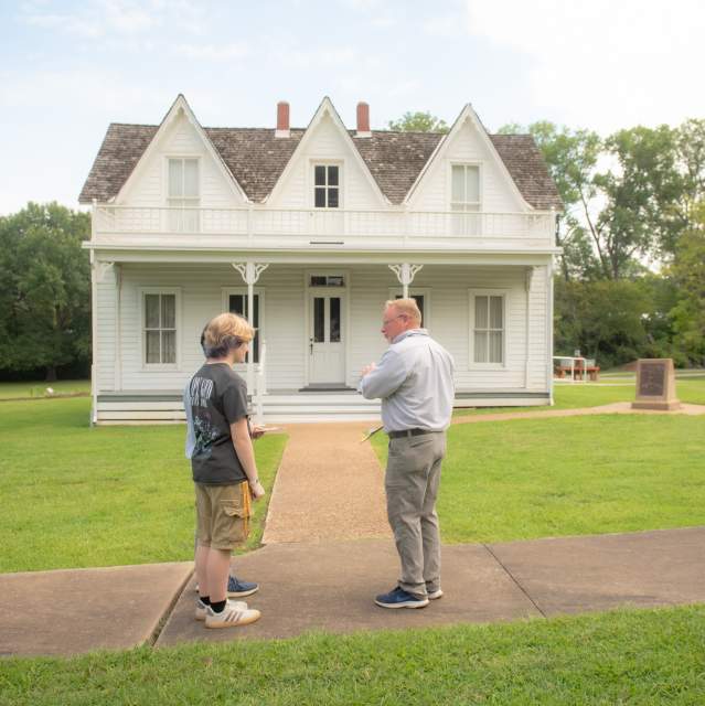 Visitors touring the Eisenhower Birthplace State Historic Site in Denison
