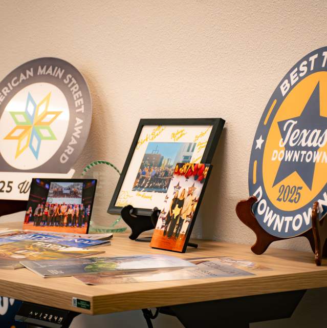 Display showcasing Downtown Denison’s tourism and Main Street awards