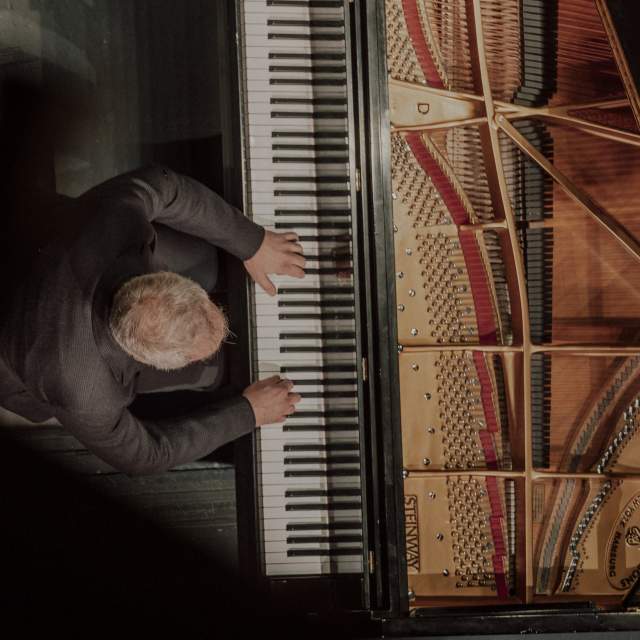 Man playing the piano from above