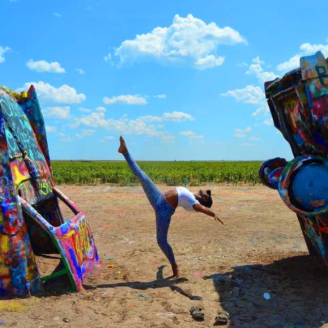 woman doing ballet pose at cadillac ranch in Amarillo, texas