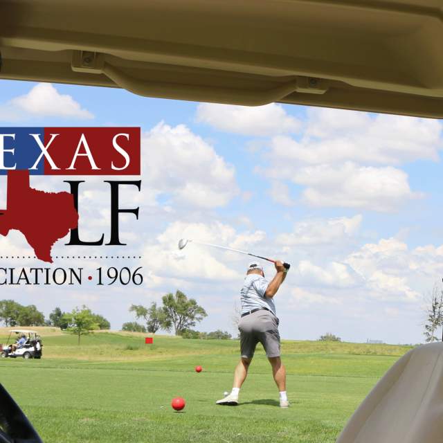 man hitting golf ball looking through a golf cart with the Texas Golf Association logo in front of him