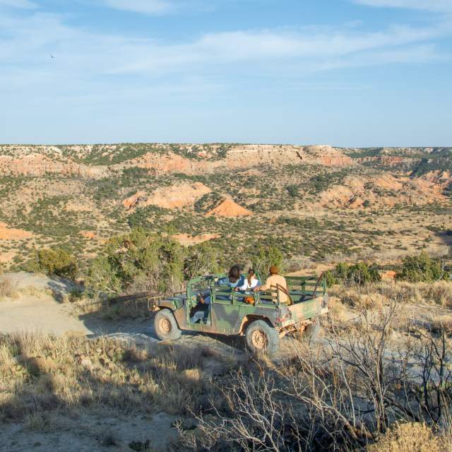 Group of friends in humvee overlooking palo duro canyon