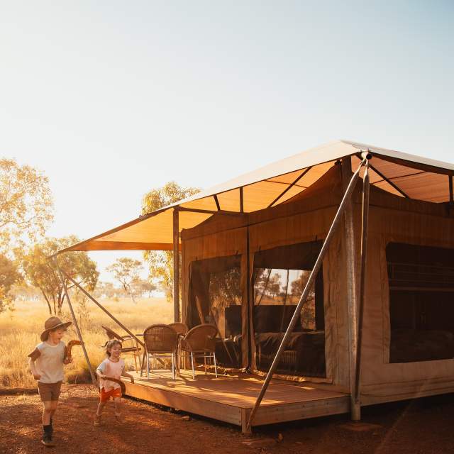 Children playing outside a family eco tent at Karijini Eco Retreat