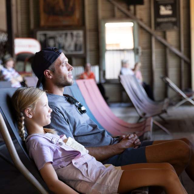 Father and daugher sitting on the deckchairs at Sun Pictures in Broome.