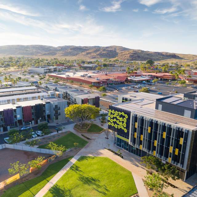 Karratha City Precinct showing buildings in The Quarter; mountain ranges in the background