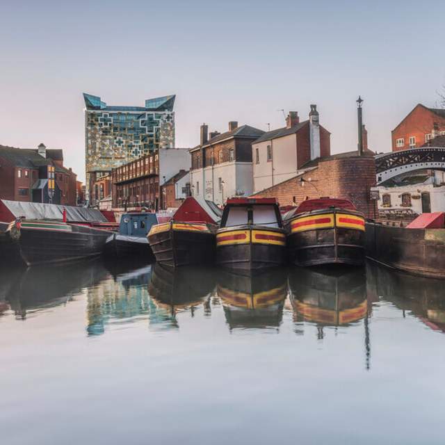 Gas Street Bain with moored canal boats and city in thebackground