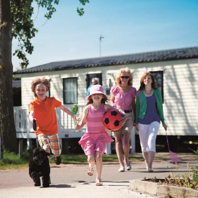 Static caravan at Waldegraves with family outside