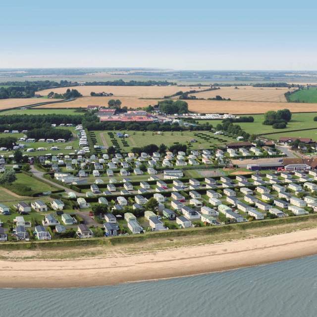 Aerial view of Waldegraves Holiday Park showing holiday homes by the beach