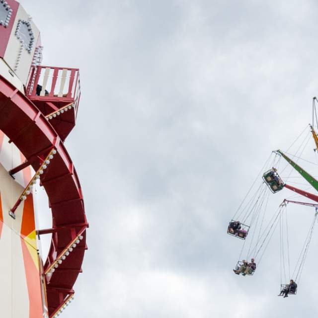 Image of hight flying swings and a helter skelter
