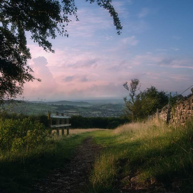 View down a gently sloping footpath with a stone wall on the right and great view ahead