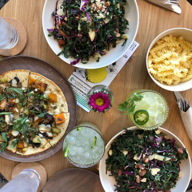 Salad, pizza and drinks at Flower Child Dallas