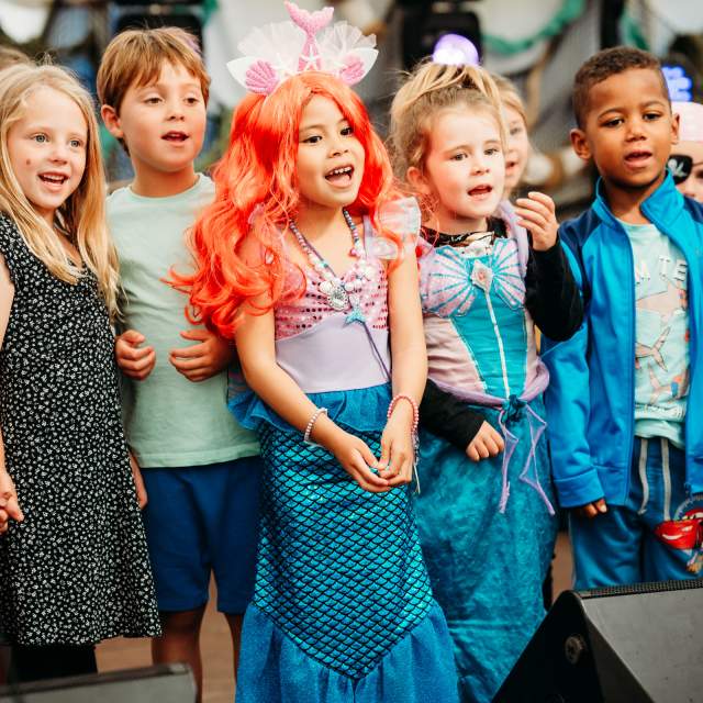 children sining at Sidmouth Sea Fest 2024