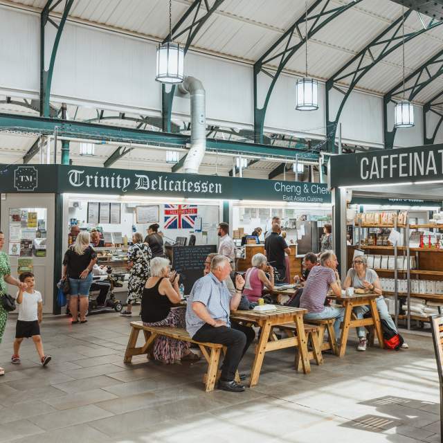 Large Foodhall with people in seating and food stalls in the background