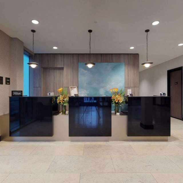 Hotel reception - 3 counters black , light floors and walls