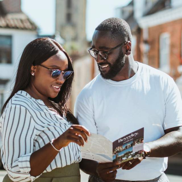 Couple looking over a Beverley map in Saturday Market