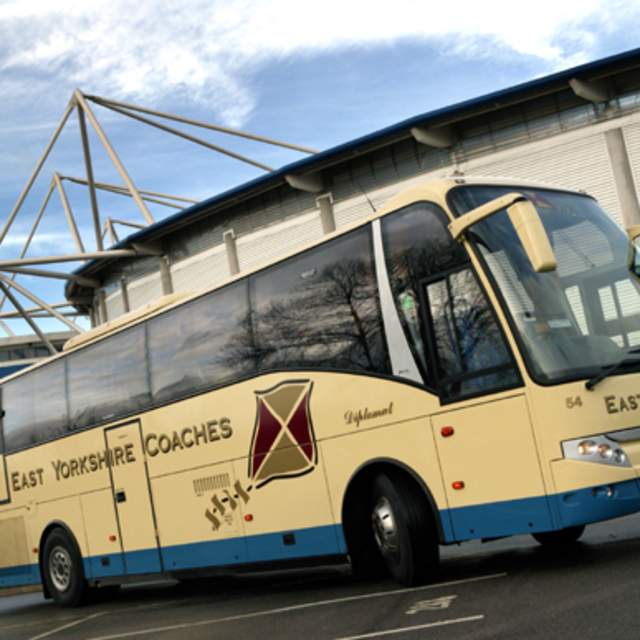 Beige East Yorkshire coach parked outside MKM Stadium Hull