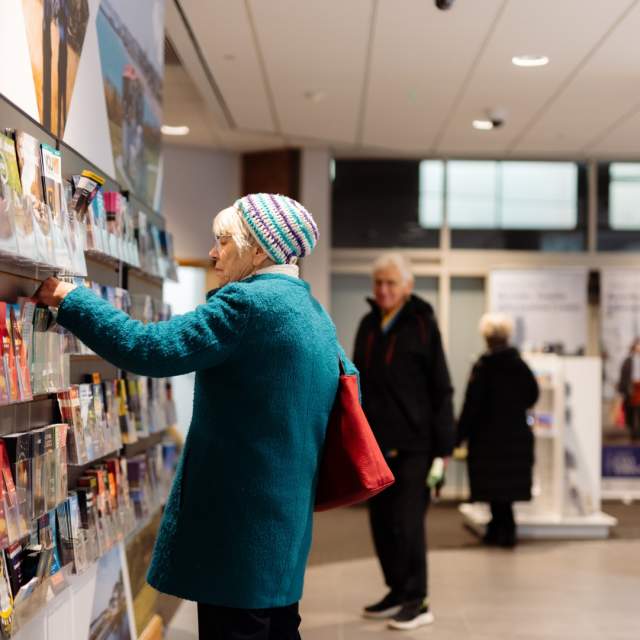 A lady choosing leaflets at Beverley TIC