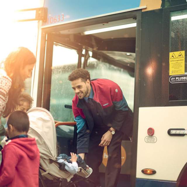 a family boarding a bus