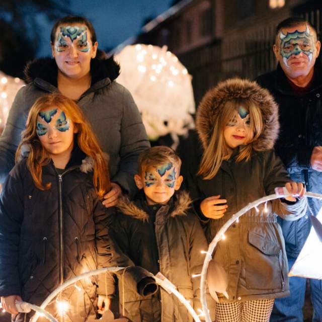 A family enjoying an Absolutely Cultured event with face paints