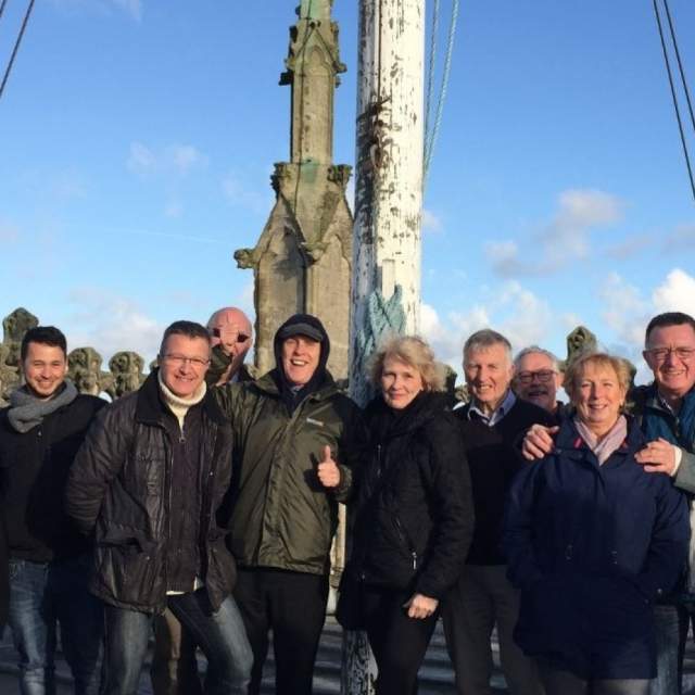 Group travel visitors standing on the rooftop viewing platform of Hull Minster, enjoying panoramic views across Hull city centre during a guided group visit.