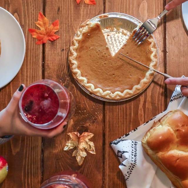 Pumpkin pie on a Thanksgiving inspired wood table