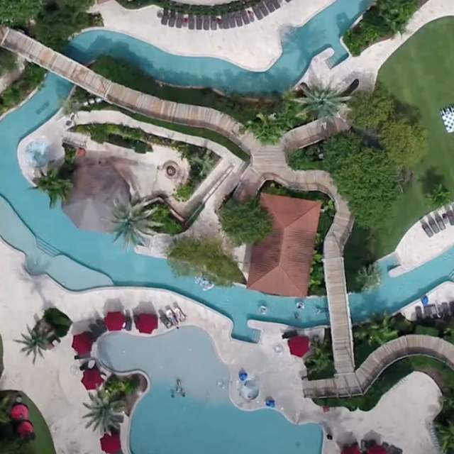 aerial view of a resort with a lazy river winding through it