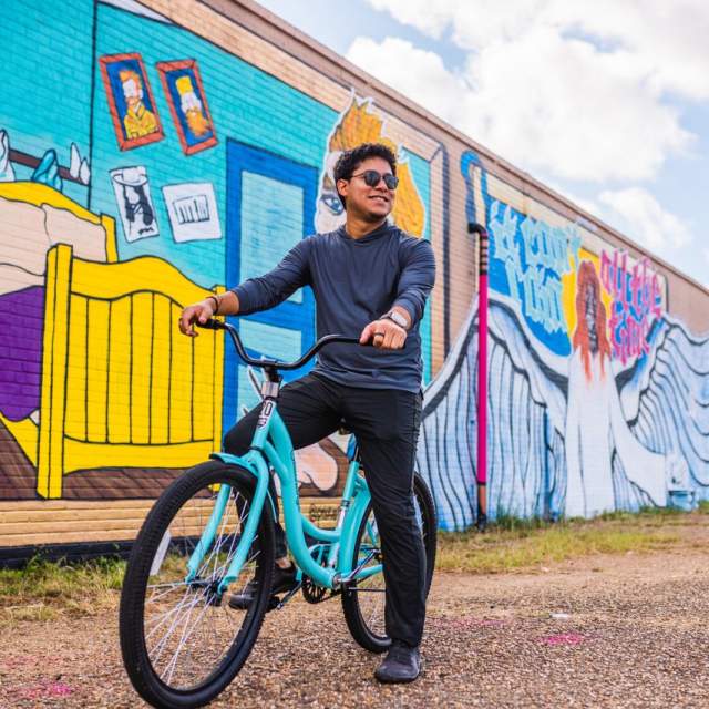 biking through the lake in front of Van Gogh murals