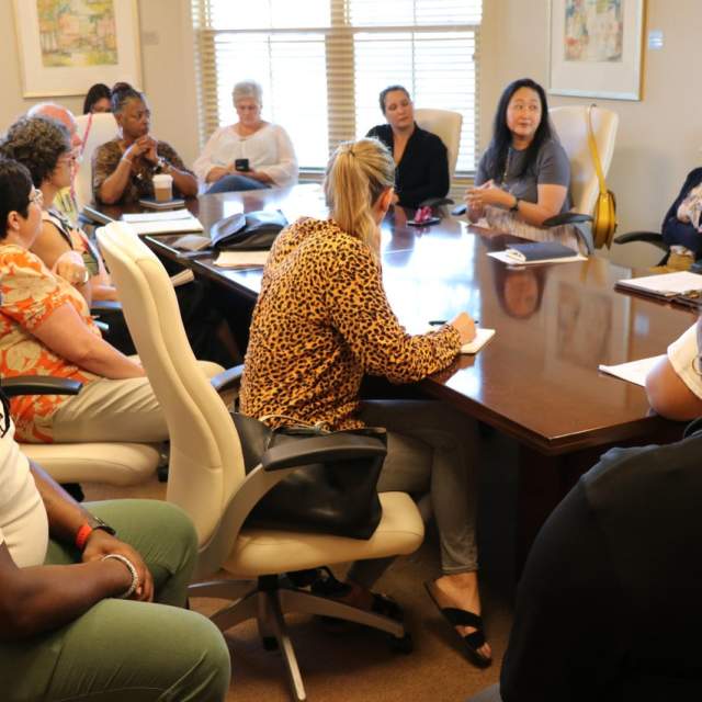 group of people gather around a table