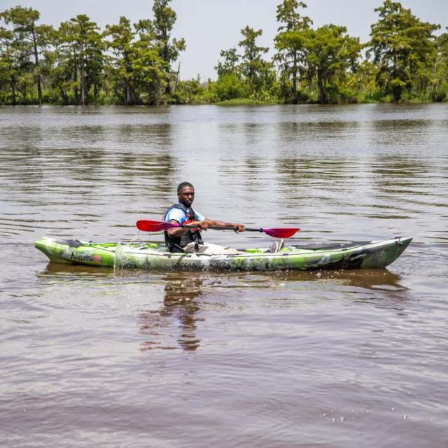man in green kayak at Riverside Park
