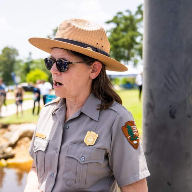 wildlife officer speaks to group at riverside